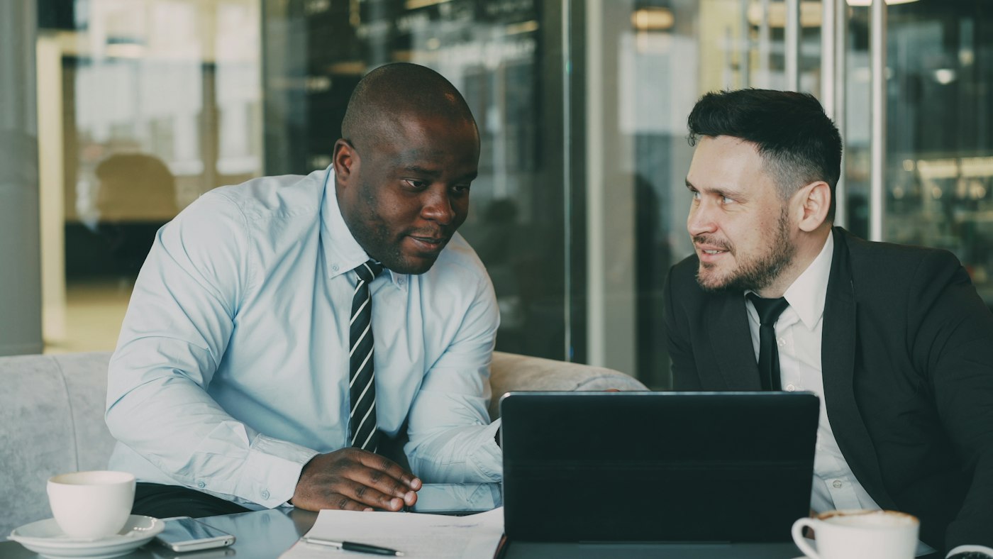 Two people discussing documents at a table