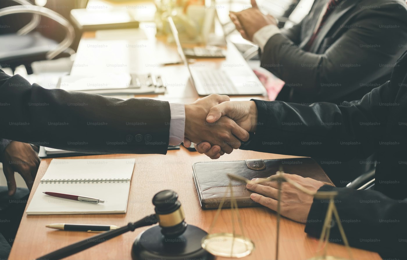 Two people shaking hands after discussing an agreement