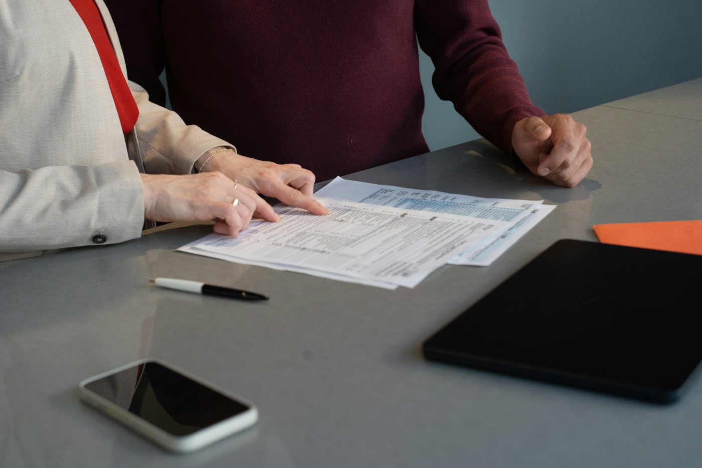 Two people reviewing paperwork at a table