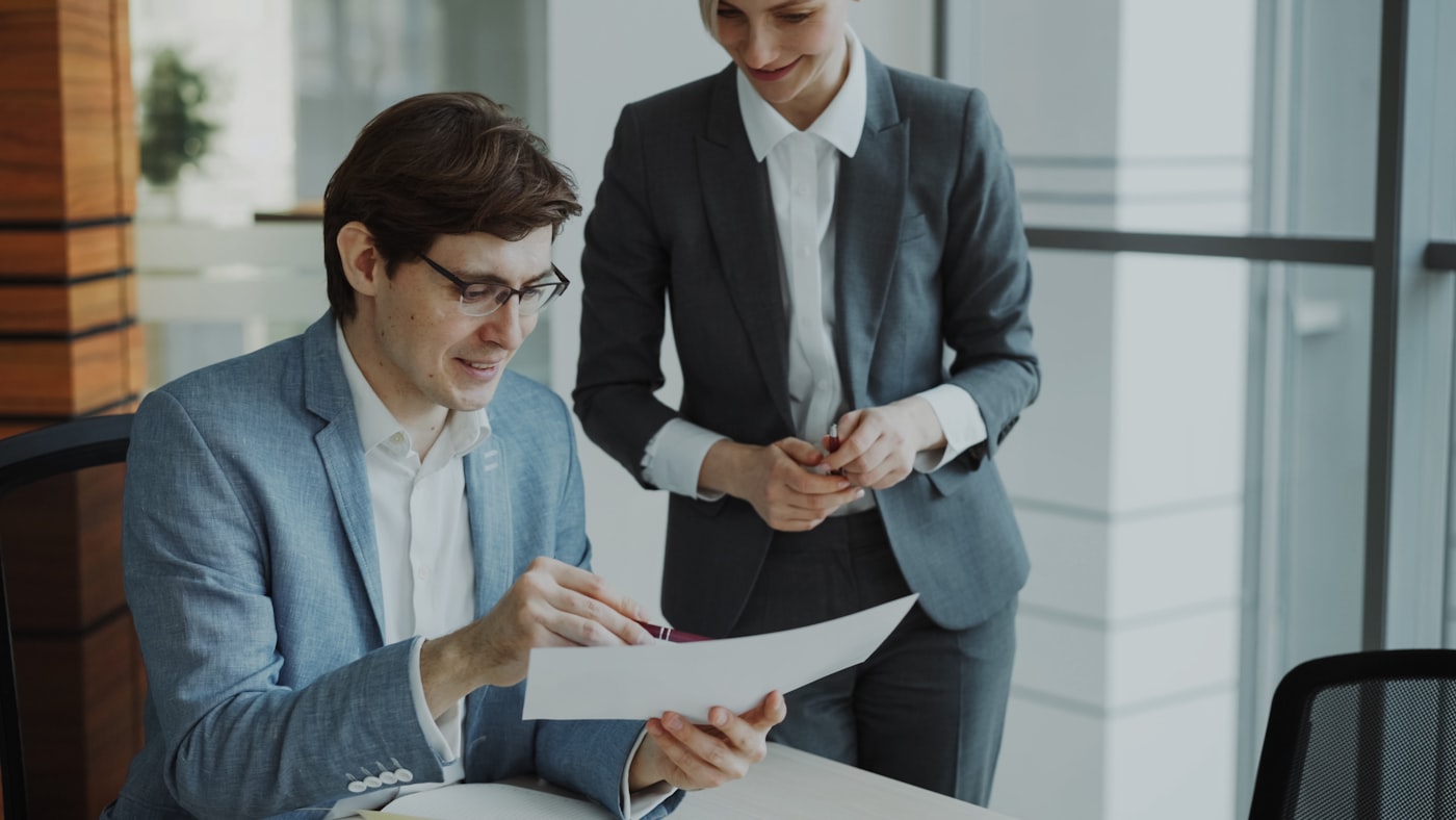 Two people reviewing documents together